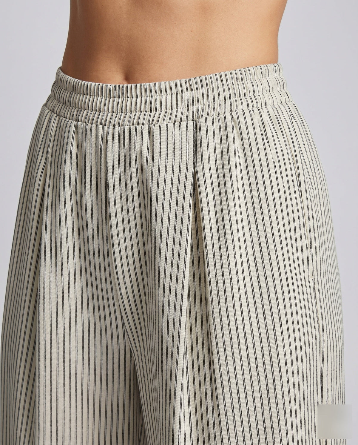 Women's High-Waisted Pleated Trousers with Wide Legs - Close-Up Detail